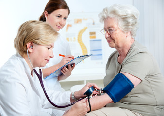 Medical exam.Measuring blood pressure - obrazy, fototapety, plakaty