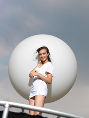 Fototapeta premium young woman on trampoline with white balloon