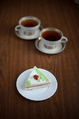 cake with cherry and a cup of tea