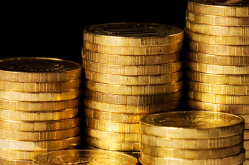 Golden coins isolated on black background