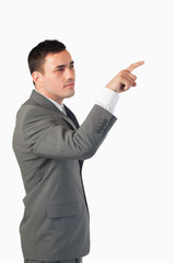 Portrait of a young businessman pressing an invisible key