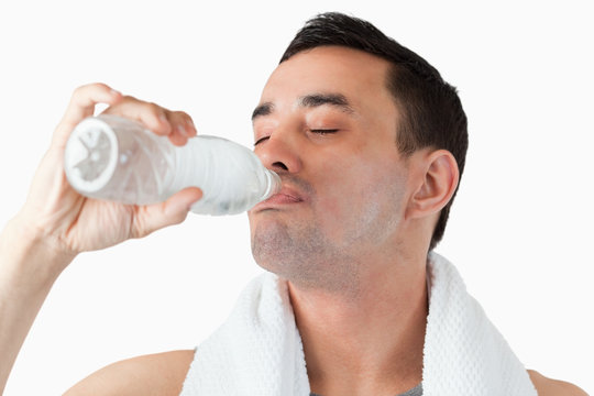Young man enjoying a sip of water after workout