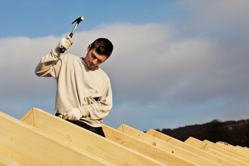 carpenters setting up a roof framework