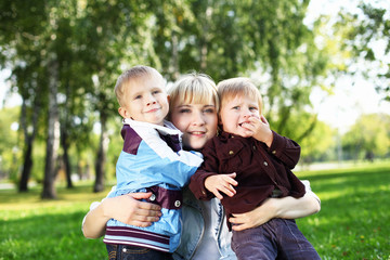 Young mother with her son in summer park