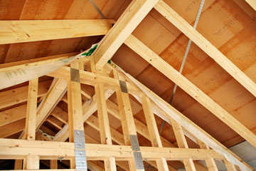 looking up to the roof structure in a modern timber-frame house