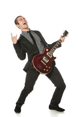 Full length of young man in a suit with guitar