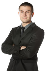 Portrait of young businessman with hands folded