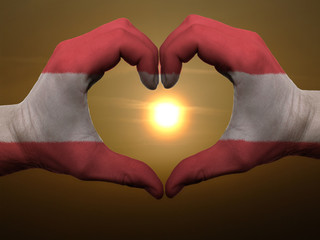 Heart and love gesture by hands colored in austria flag during b