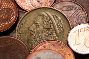 Old greek coin among euro coins, drachmas