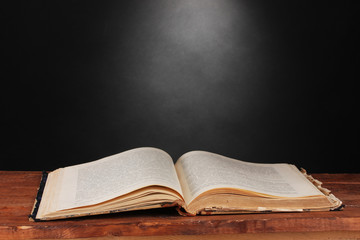 old book on wooden table on gray background