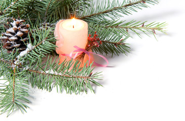 branch of Christmas tree with candle and  pinecone
