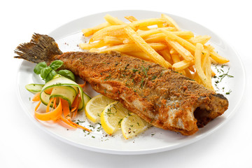 Fish dish - fried fish, French fries and vegetables