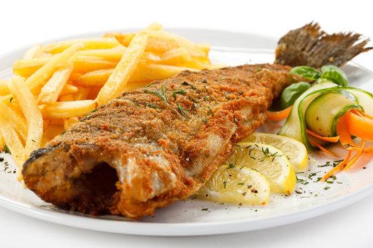 Fish dish - fried fish, French fries and vegetables