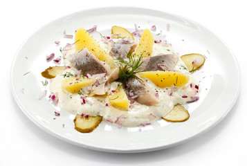 Marinated herring fillets with cream and vegetables