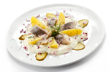 Marinated herring fillets with cream and vegetables