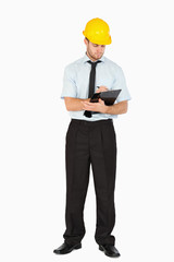 Young foreman taking notes on his clipboard