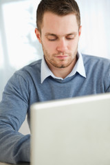 Young man typing on laptop