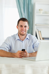Fototapeta premium Businessman texting on his cellphone