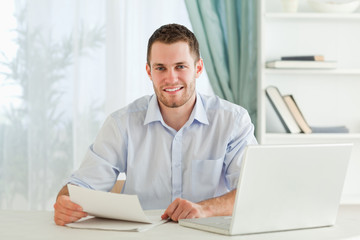Smiling businessman holding a letter