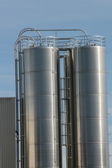 View of an industrial plant with large aluminum tanks