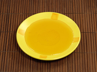 Honey in yellow plate.