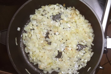 Onion being fried on a pan