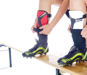 girls putting on their soccer shin guards