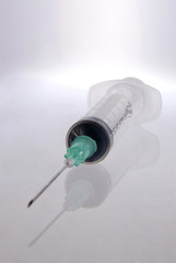 Syringe with reflection over clear background