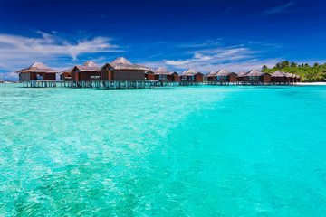 Overwater bungallows in blue lagoon
