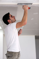 Man plastering ceiling