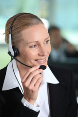 Woman smiling holding headset