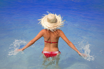 Naklejka premium Happy Woman in azure swimming pool