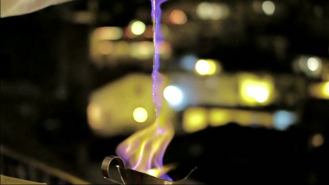 Waiter preparing flambe cocktail