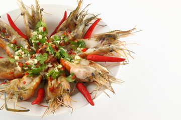 Part of spicy dressed salad prawn in round plate.