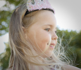 little girl dressed as princess in backyard