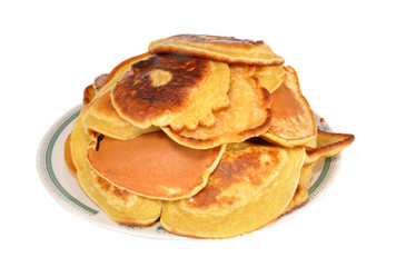 The heap of pancakes lies in a plate