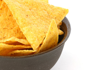 Mexican tortilla chips in brown bowl on white background