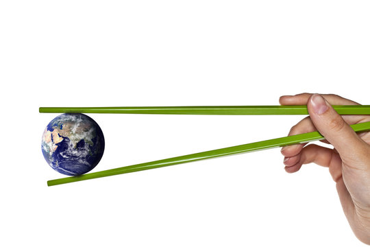 blue planet earth between green chopsticks