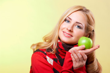 Young woman holding green apple