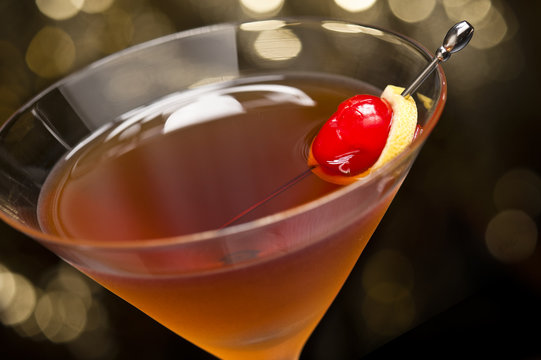 Manhattan Cocktail Garnished With A Cherry And Lemon