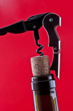Bottle with a cork and corkscrew