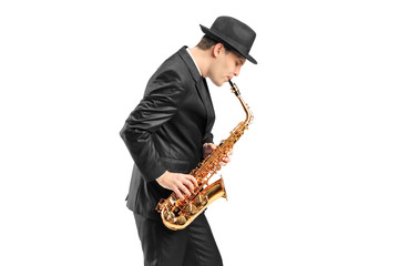 A young man playing on saxophone