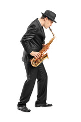 Full length portrait of a young man playing on saxophone