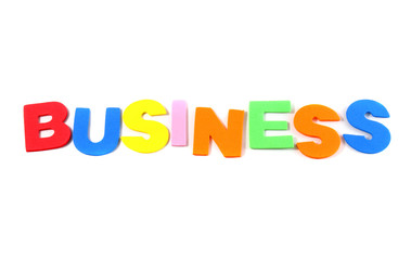 Business in colorful toy letters on white background
