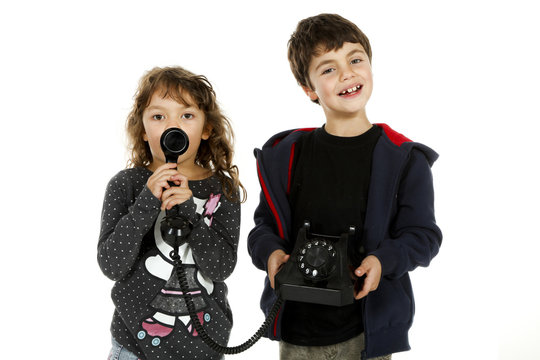 Portrait of two children with phone, white background