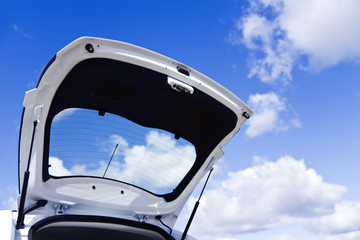 Fototapeta na wymiar Open luggage carrier of the car against the blue sky