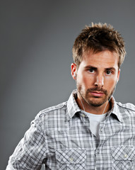 Serious young man listening to music