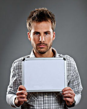 Serious Young Man Holding Sign