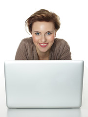 Pretty woman behind her laptop surfing on the internet