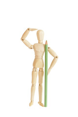 Wooden figure holding green pencil and looking
